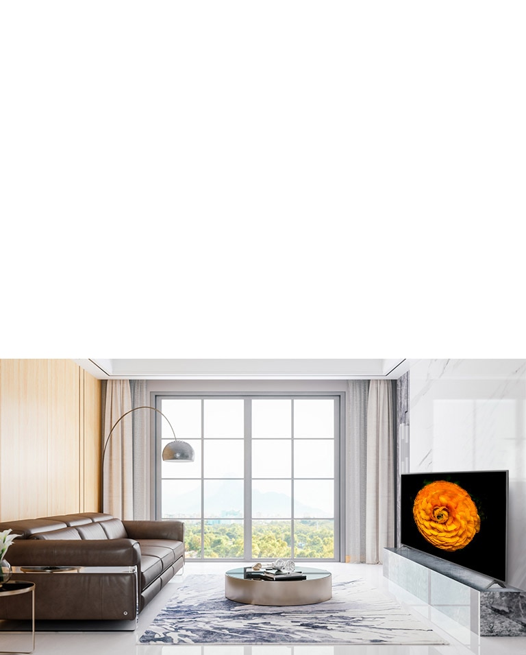 LG UHD TV, located on the wall in a living room with the minimal interior. Image of a flower is shown on the TV screen.