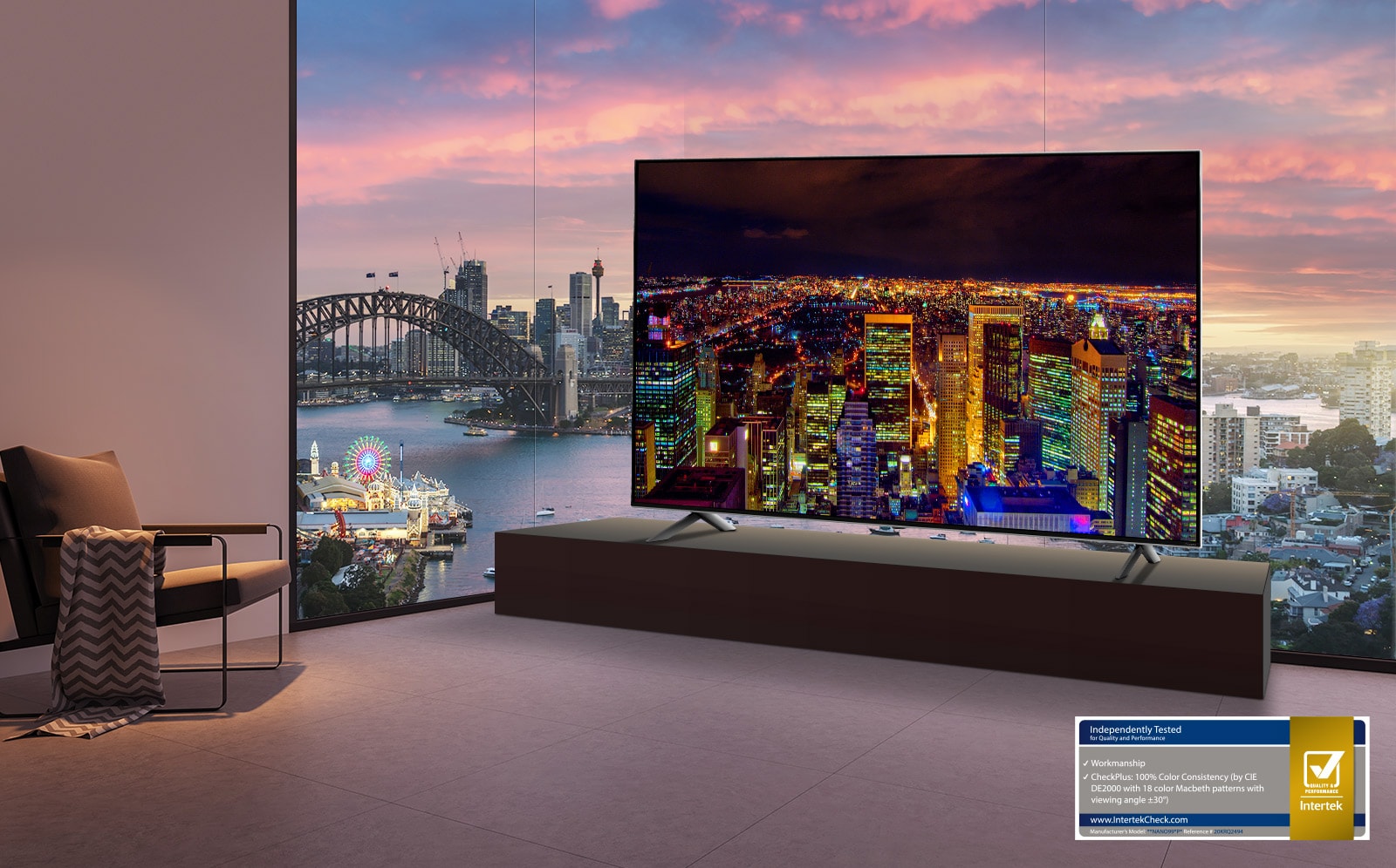 Room overlooking a river and cityscape. A TV is installed in front of the window showing a night view of a city skyline against a dark sky.