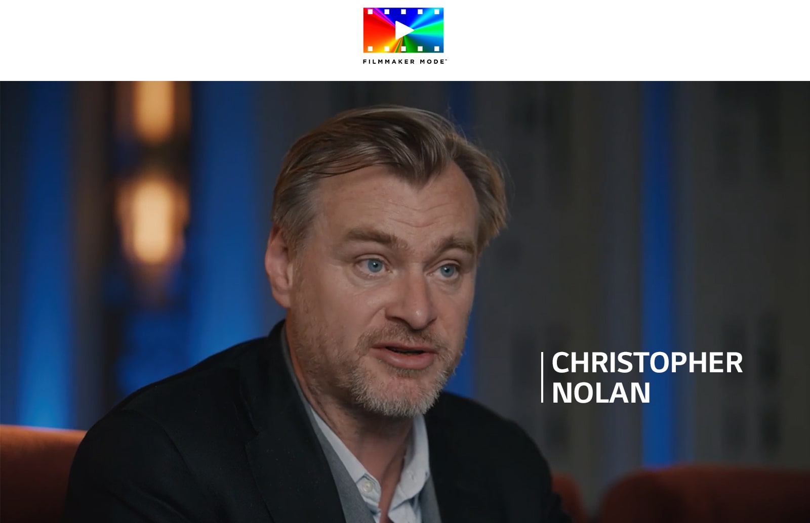 A logo of FILLMAKER MODE™. Under the logo, Christopher Nolan is having an interview in a dark room.